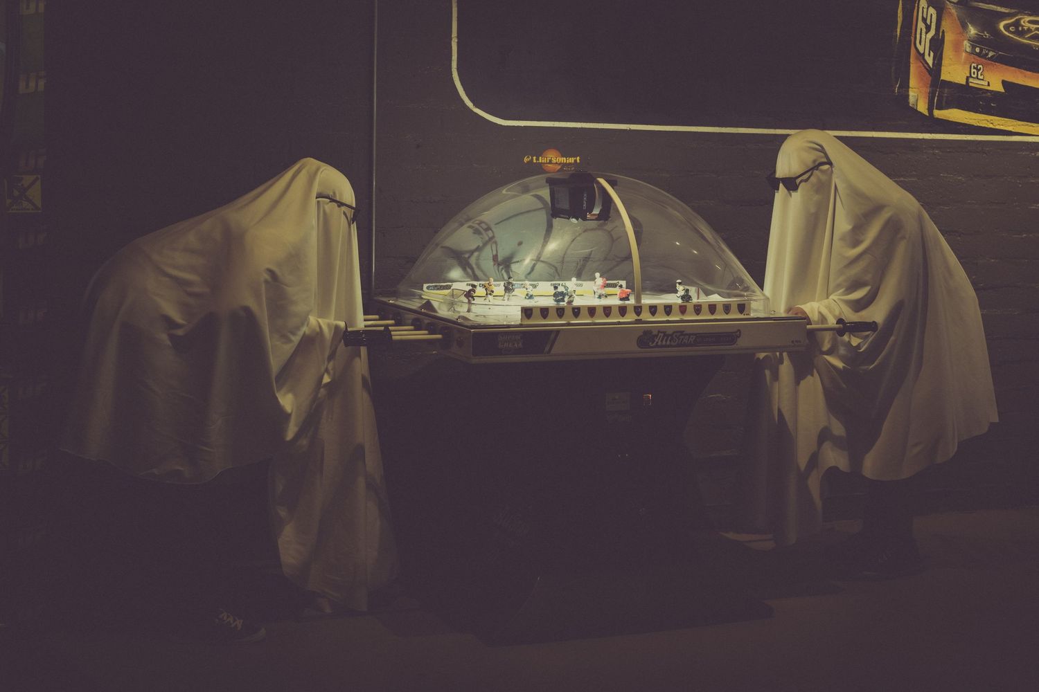 A dark and moody montage of scenes from a theatrical performance with dramatic lighting and flowing costumes.
