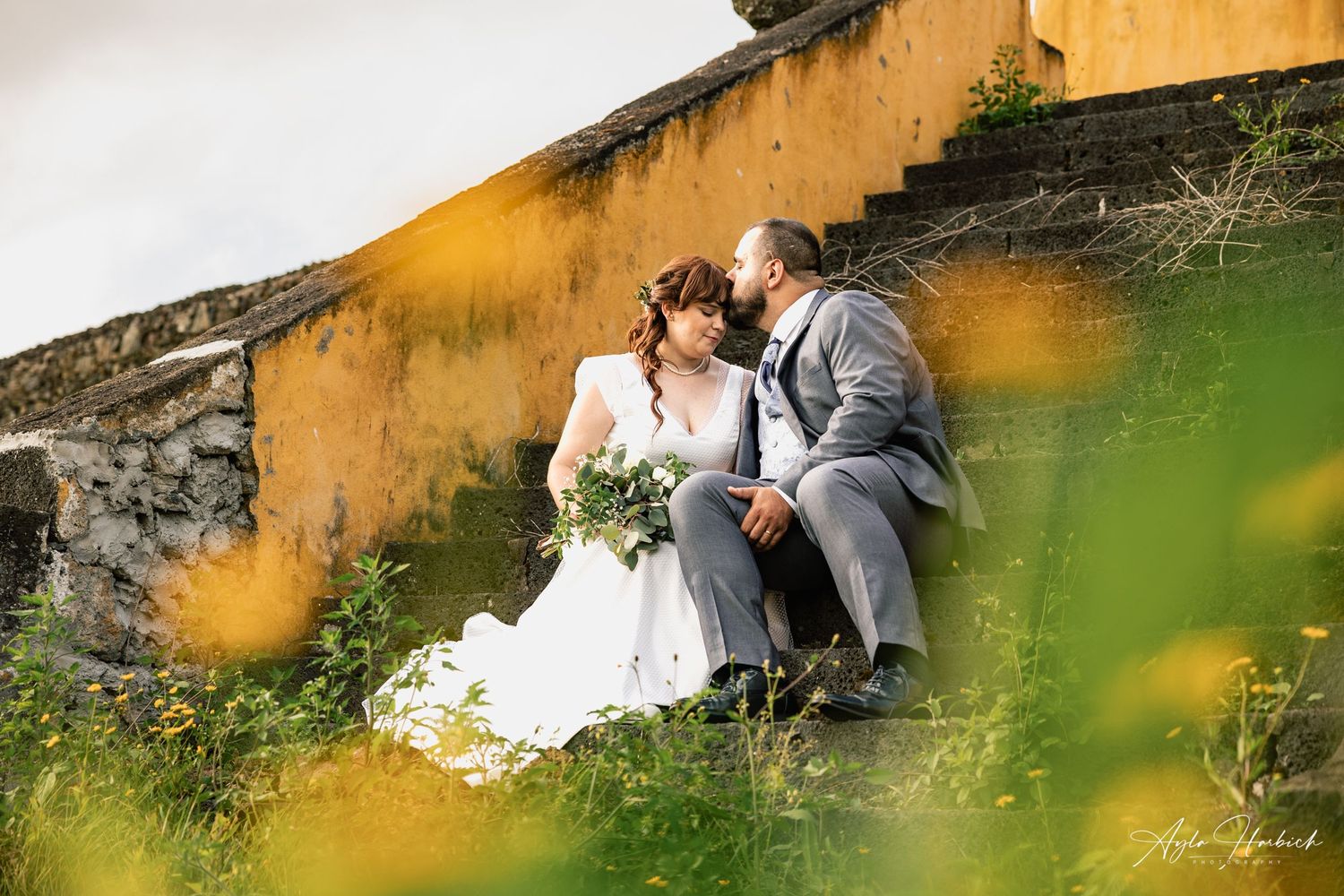 Wedding day: bride and groom during the photo session in a beautiful property outdoors. Sharing a special and intimate moment.