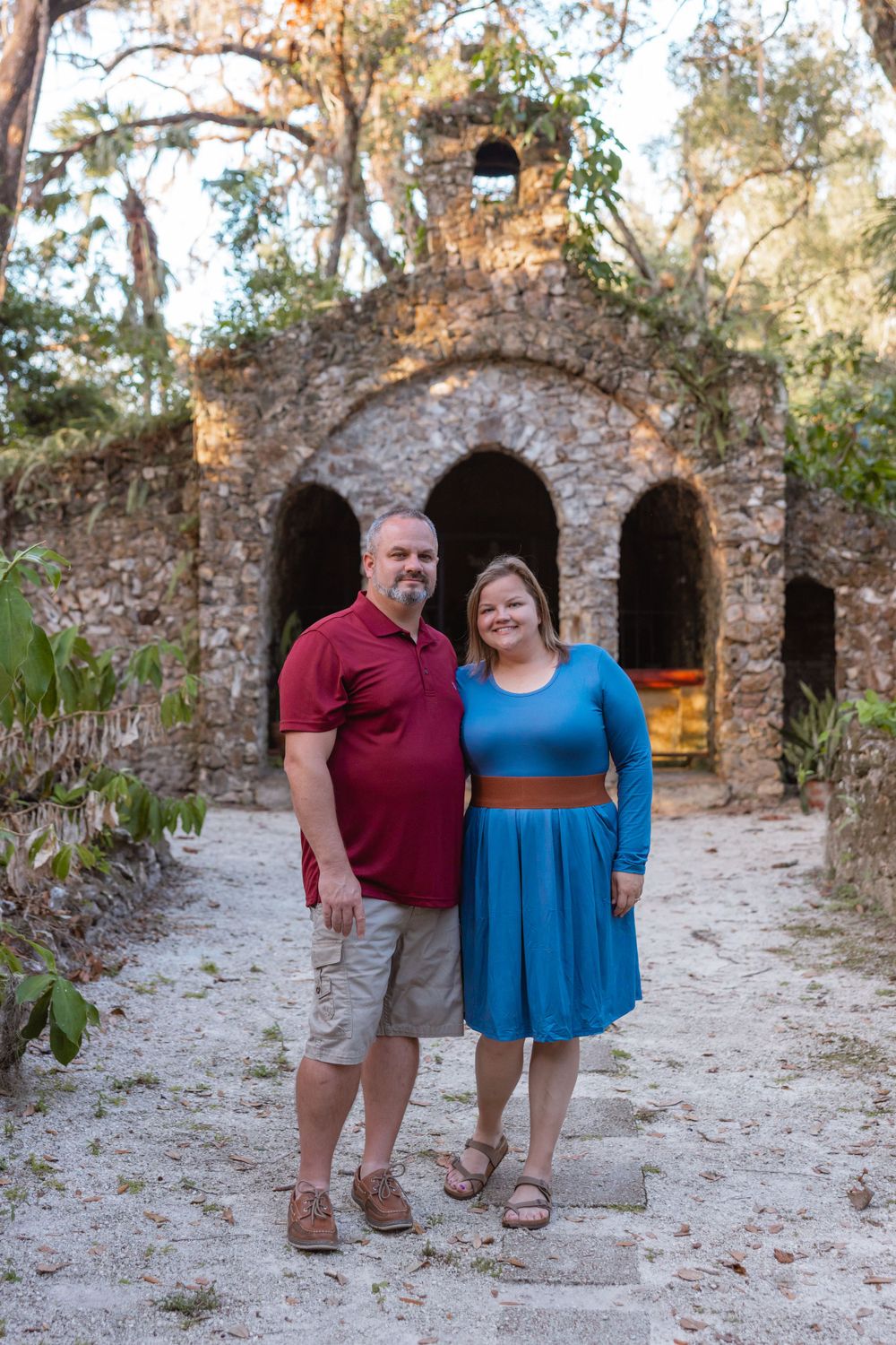 Couple posing at the Grotto of Our Lady of Lourdes at Saint Leo University in Florida