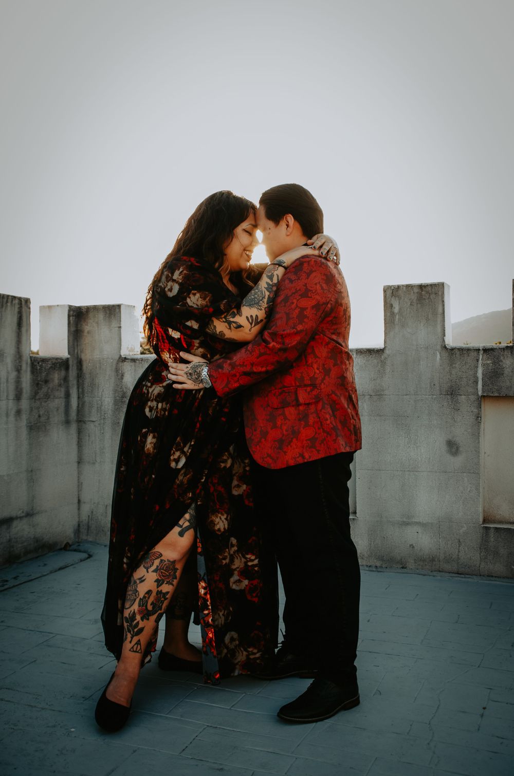 Engaged couple embracing and smiling, capturing a joyful and intimate moment during their engagement photo session