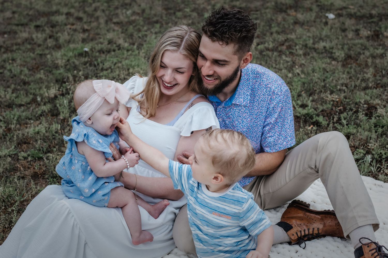 Family enjoying quality time together on grass outdoors.