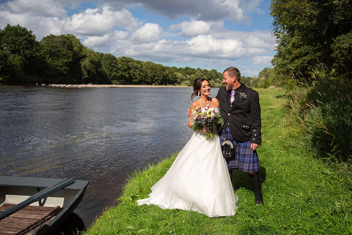 Bride and groom on the banks of the river Spey