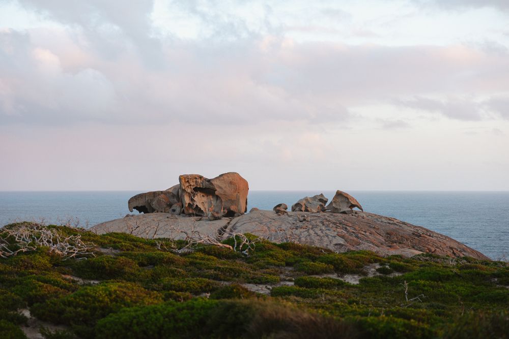 Remarkable Rocks formation on Kangaroo Island at sunset against cloudy skies.