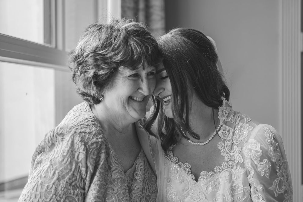 Tender black and white moment shared between two people during a wedding celebration.
