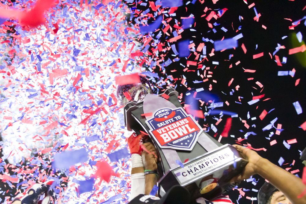 Championship trophy celebration with red white and blue confetti raining down.