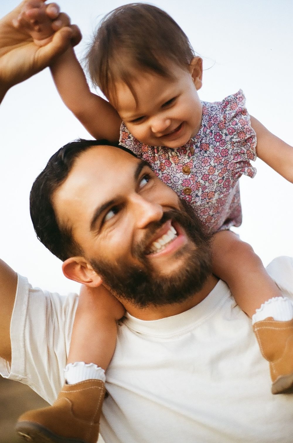 Film family photo of a dad and daughter sharing a candid moment