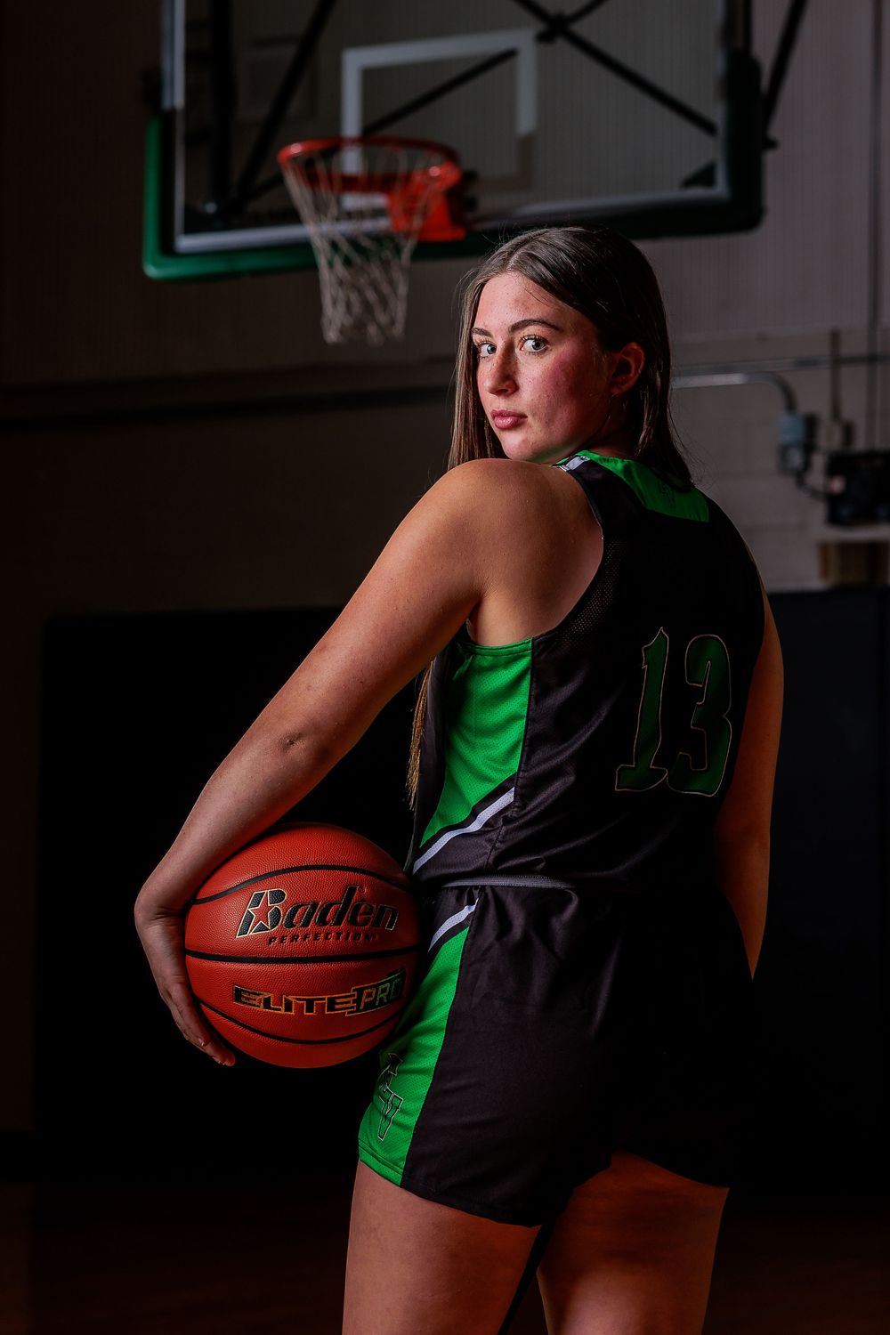 East Valley High School basketball portrait by Chris Elam Photography in Spokane, WA, featuring a female with green smoke and a basketball
