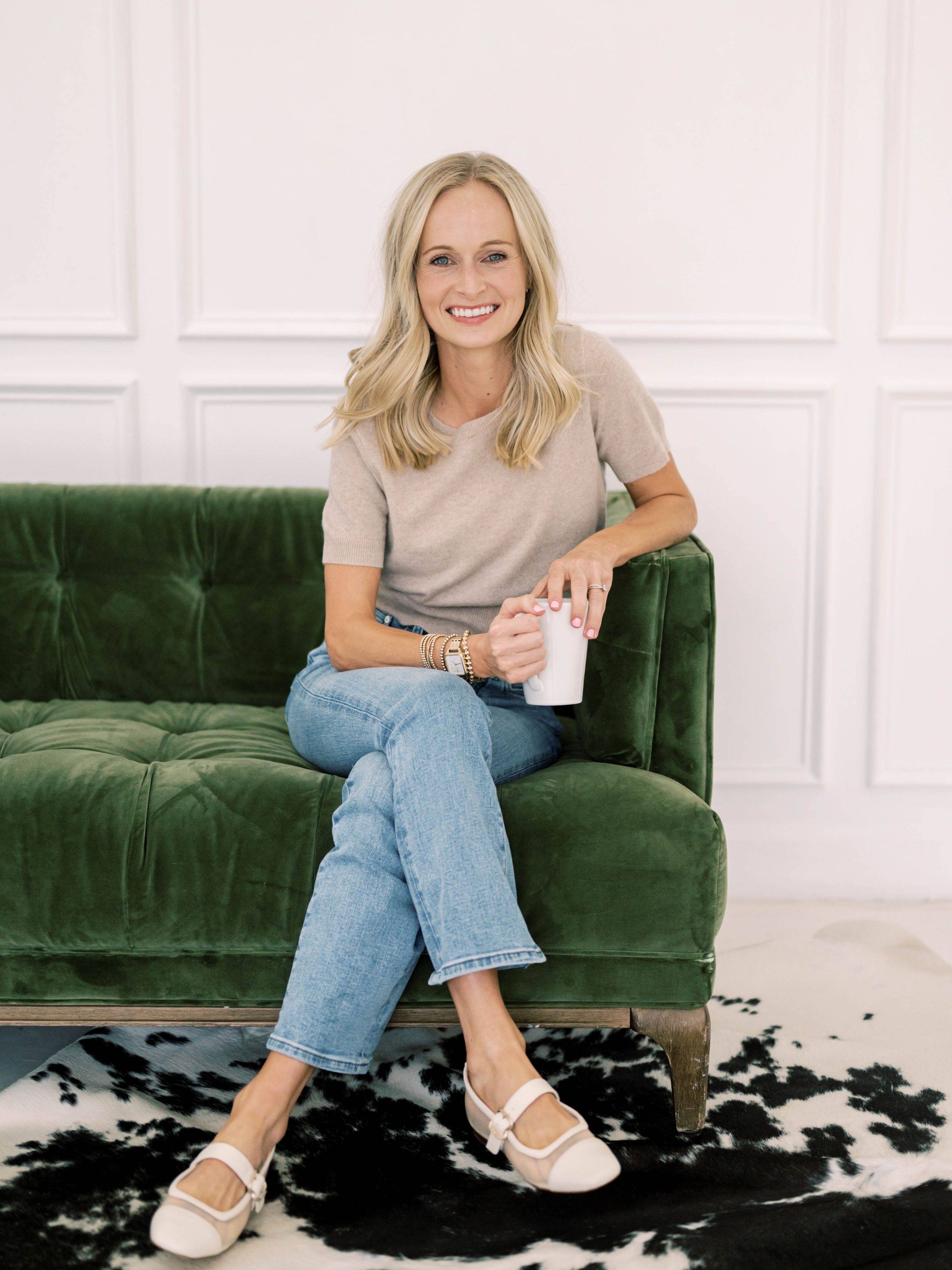 professional branding shot of blonde girl with a coffee mug on a couch