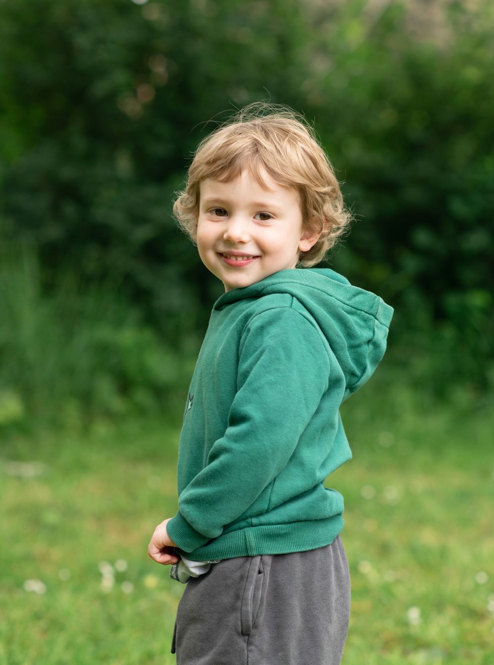A  small boy smiling for his nursery photos