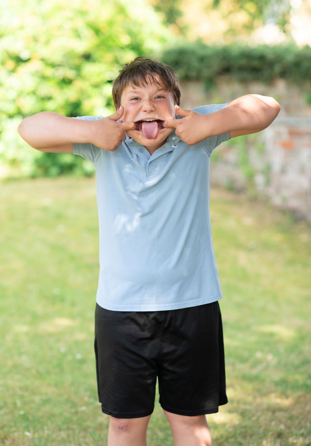 A boy pulling a silly face for school photos
