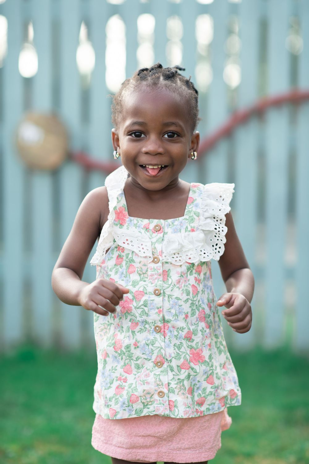 A toddler smiling and playing on nursery photo day in Ripn, North Yorkshire.