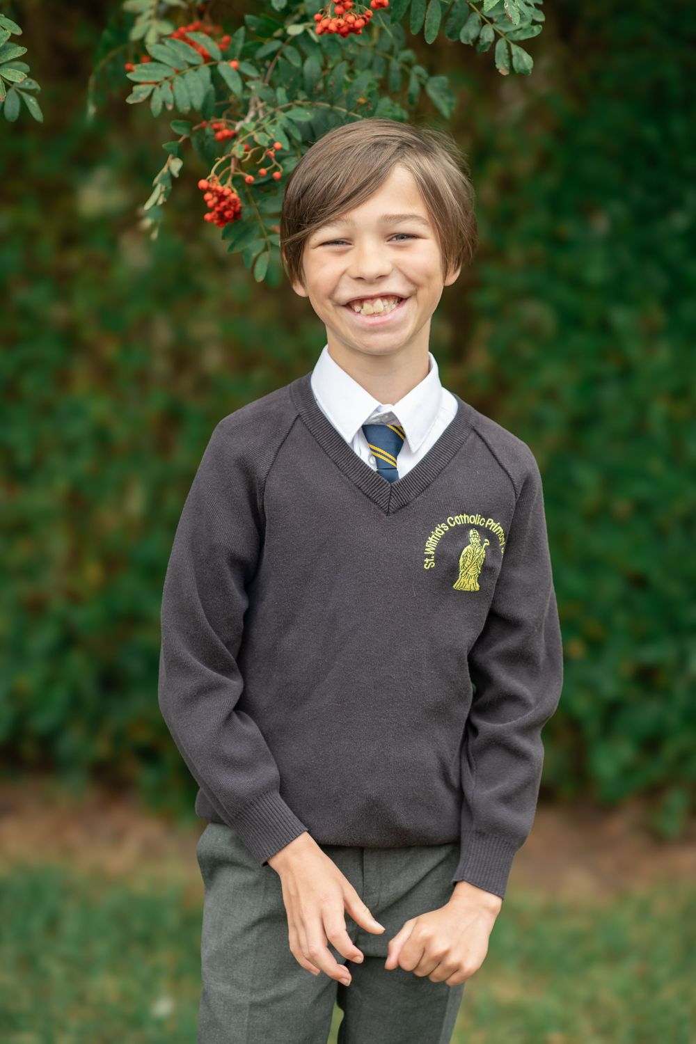 A smiling boy stood for a natural school photo, taken in North Yorkshire.