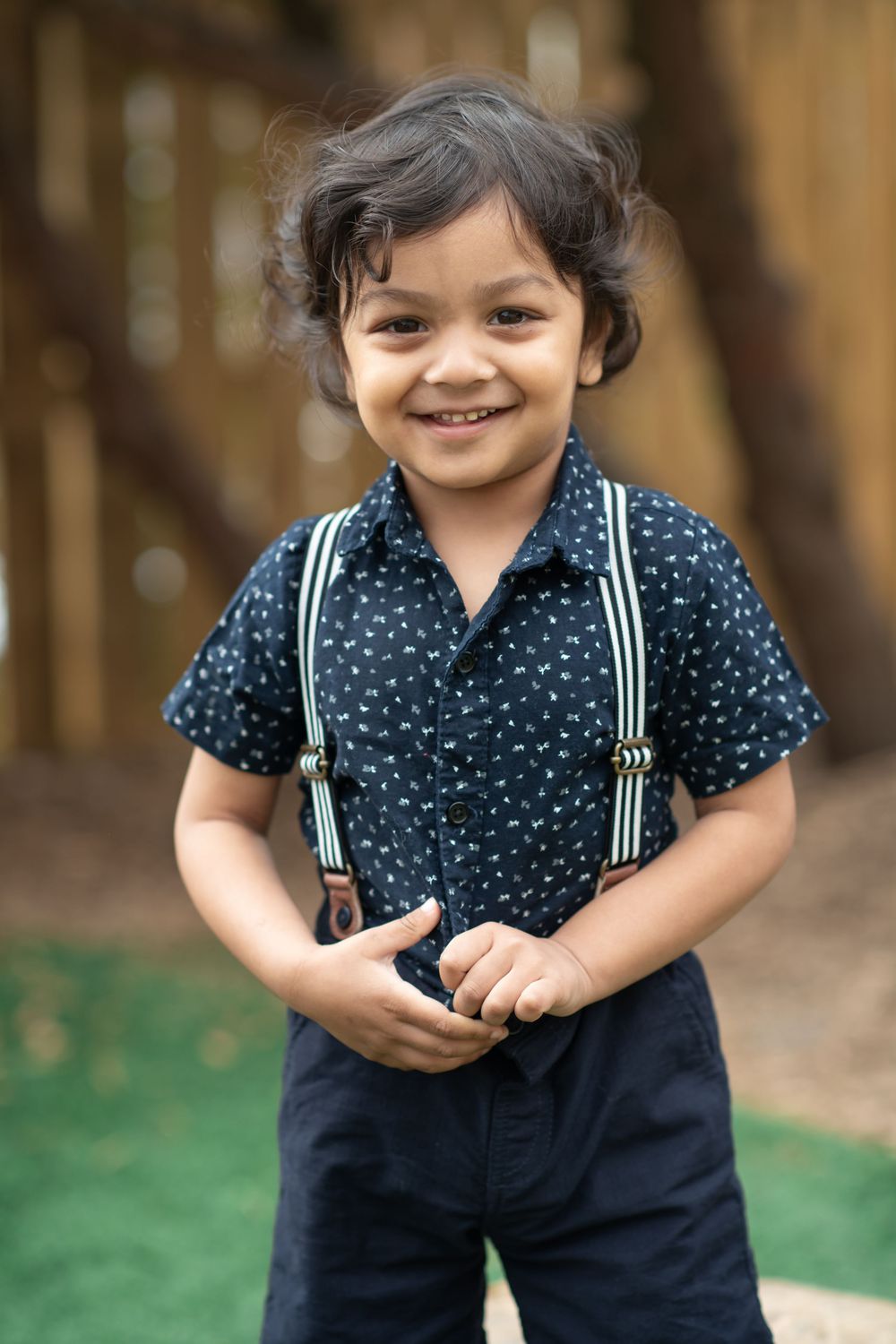 A child smiling for his nursery photos