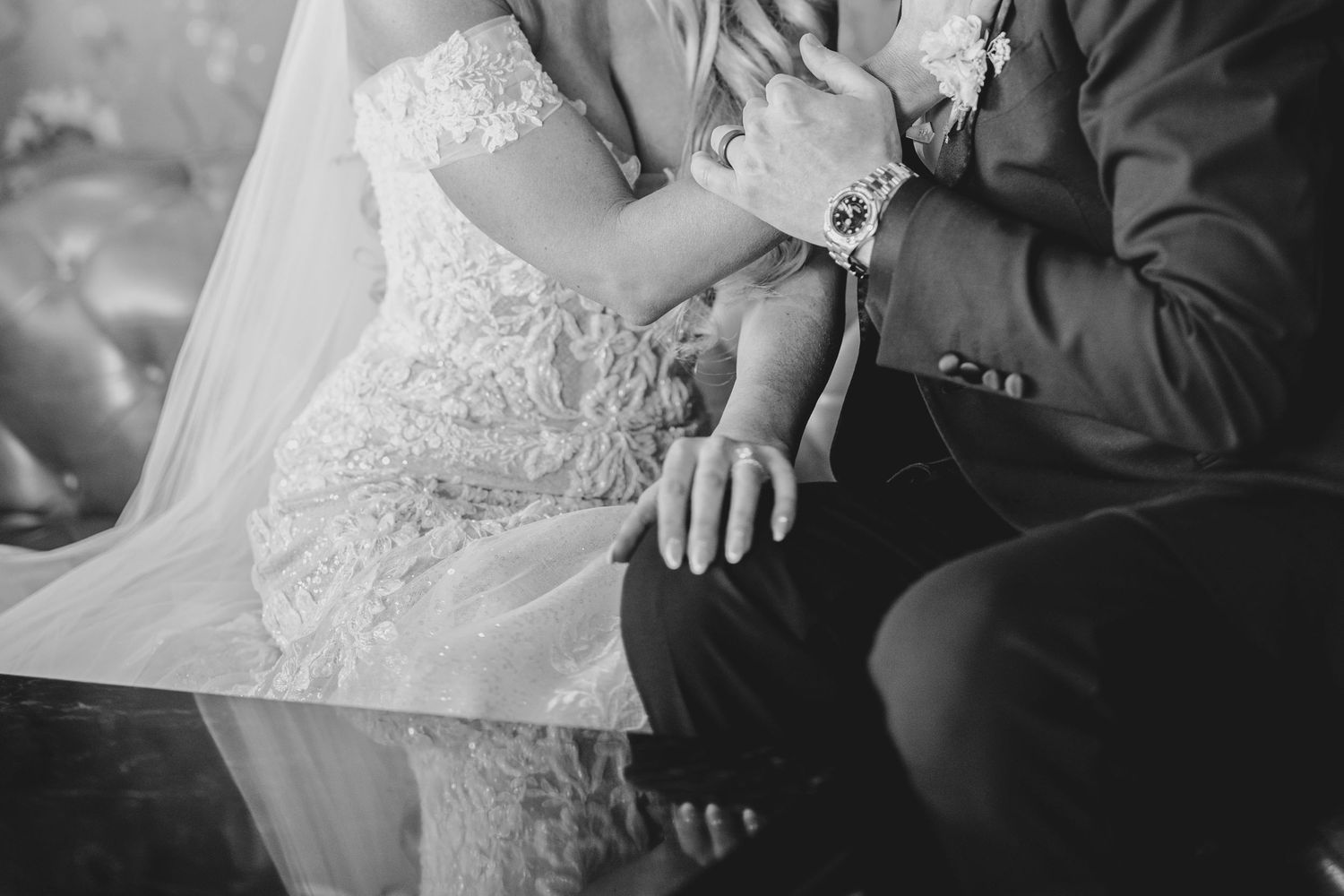 A row of black and white wedding photographs showing intimate moments between a bride and groom.