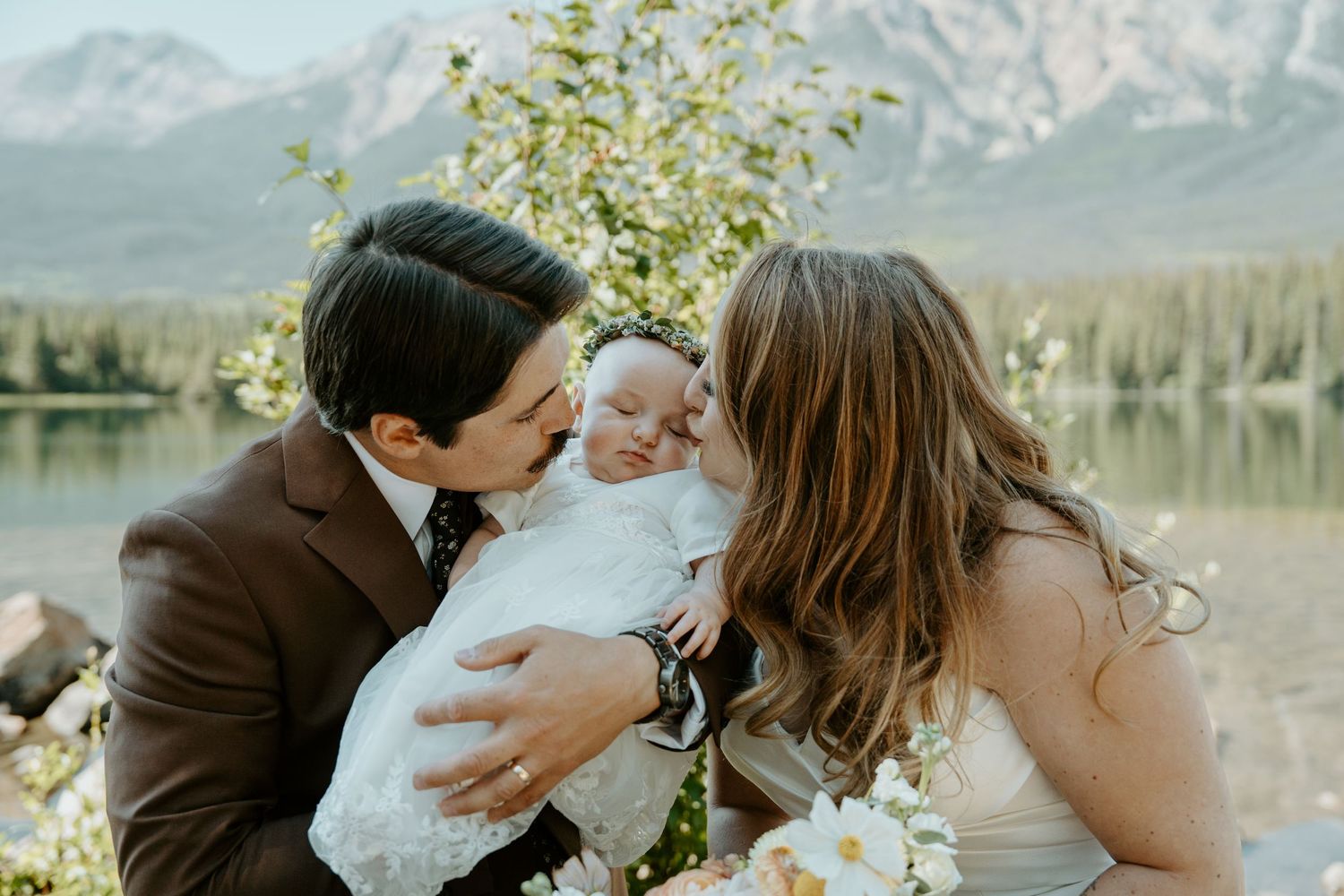 Romantic couple shares tender moments in multiple photos against a scenic mountain lake backdrop.