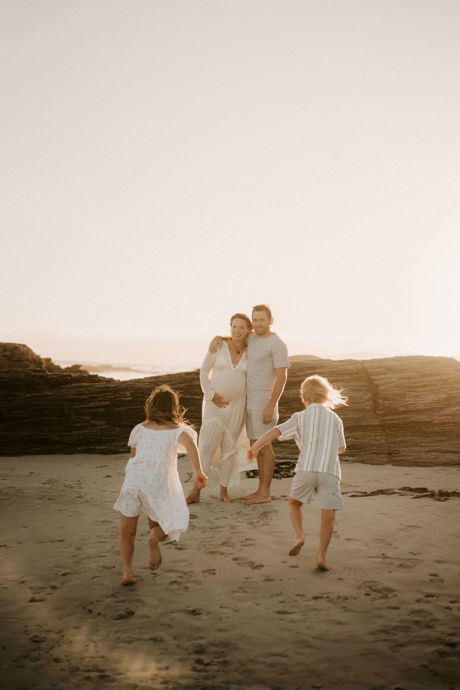 Sweet family moment with infant in lace headband being held and kissed.