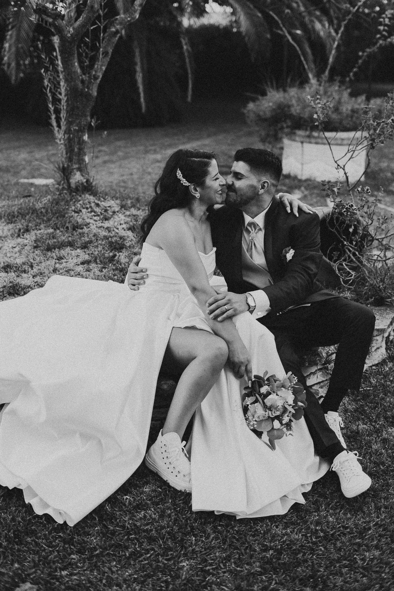 Black and white photo series of couple laying in grass during romantic outdoor photoshoot.