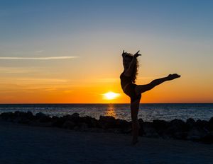 Dance photoshoot at Westport beach featuring flowing movement, ocean backdrop and golden hour lighting