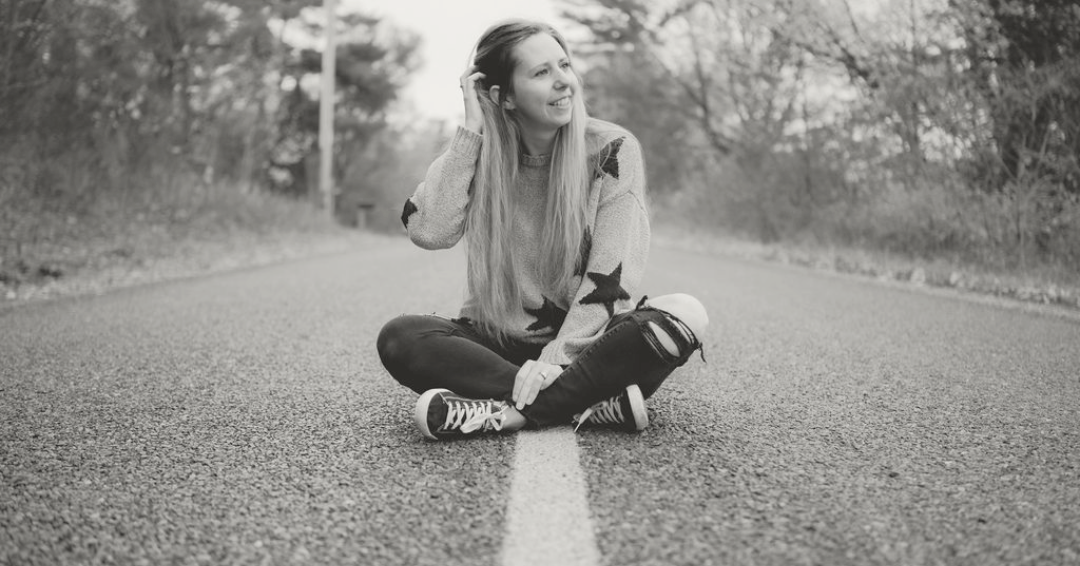A black and white photo series shows someone sitting on a gravel path.