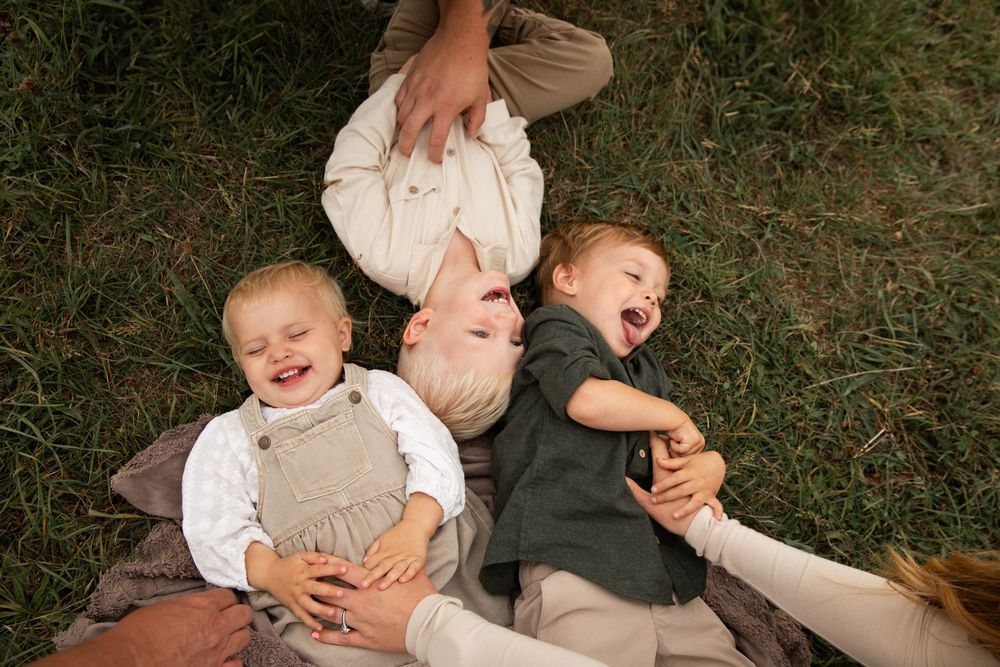 A collection of candid family photos arranged in a horizontal strip showing playful outdoor moments in casual attire.