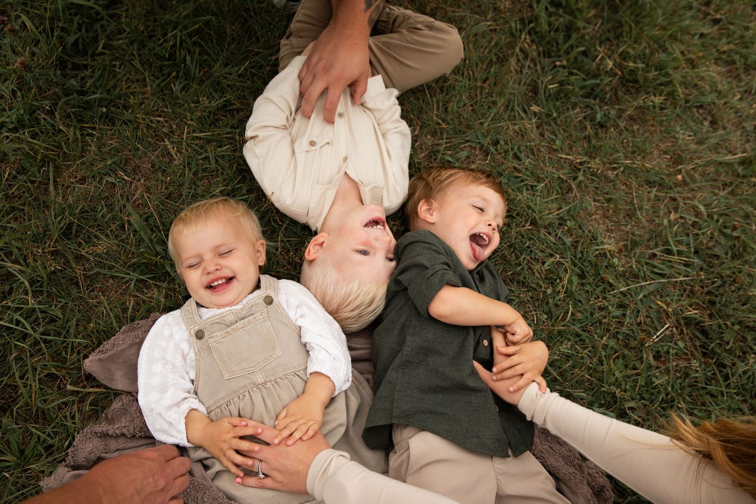 A collection of candid family photos arranged in a horizontal strip showing playful outdoor moments in casual attire.