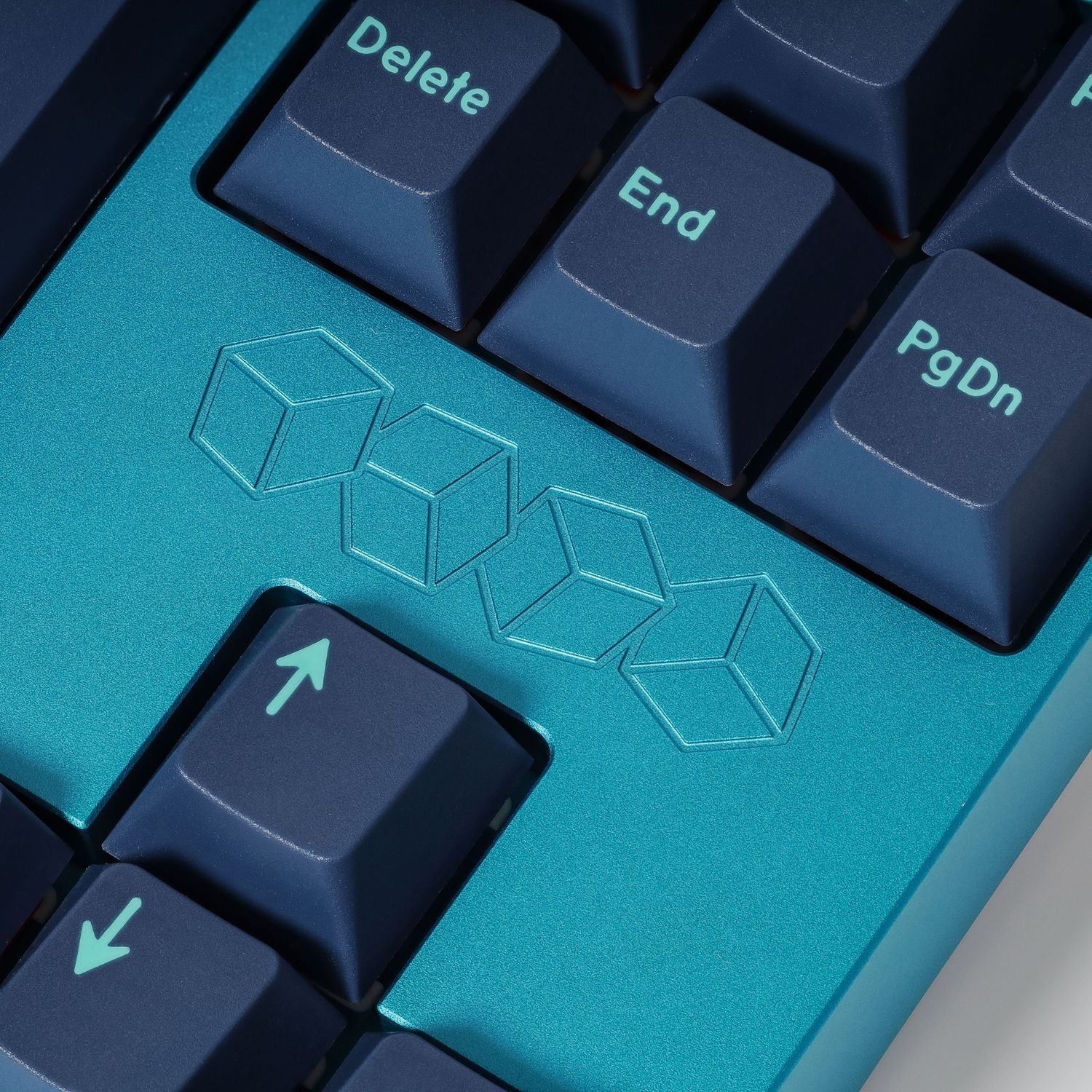 Close up of mechanical keyboard keys showing delete and end buttons with geometric designs.