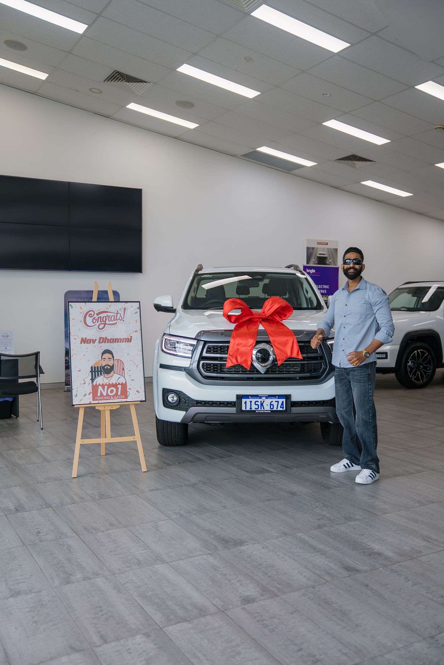 A sequence of photos showing a car delivery celebration with a sign and red bow in an indoor parking garage.