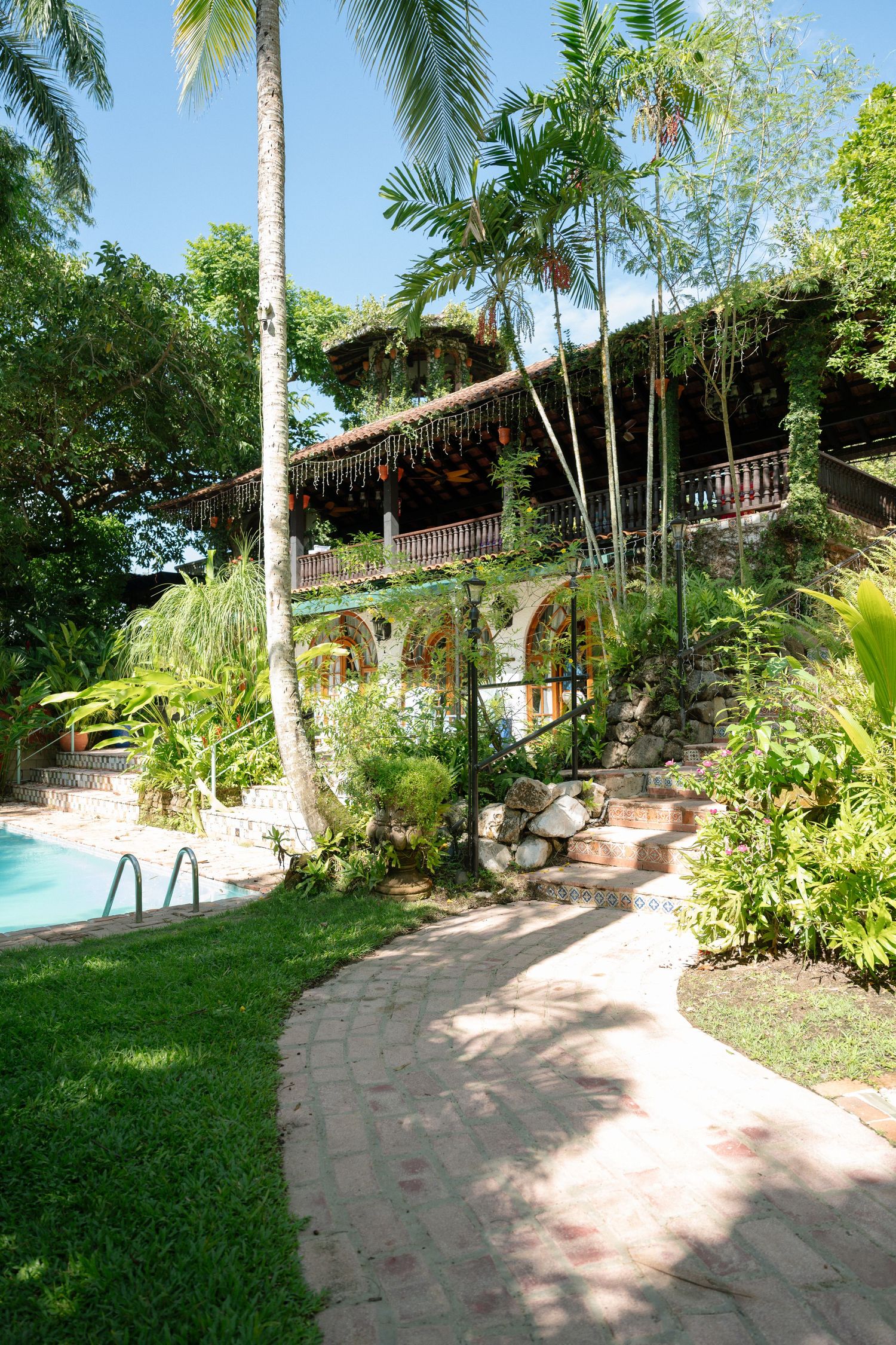 Tropical wedding venue with lush greenery, poolside garden, and rustic villa in the Puerto Rico