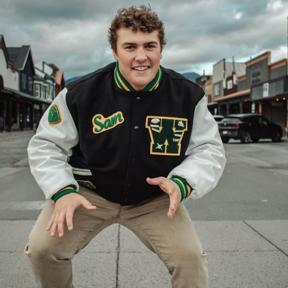 Athletic letterman jacket photos taken against urban street backdrop.