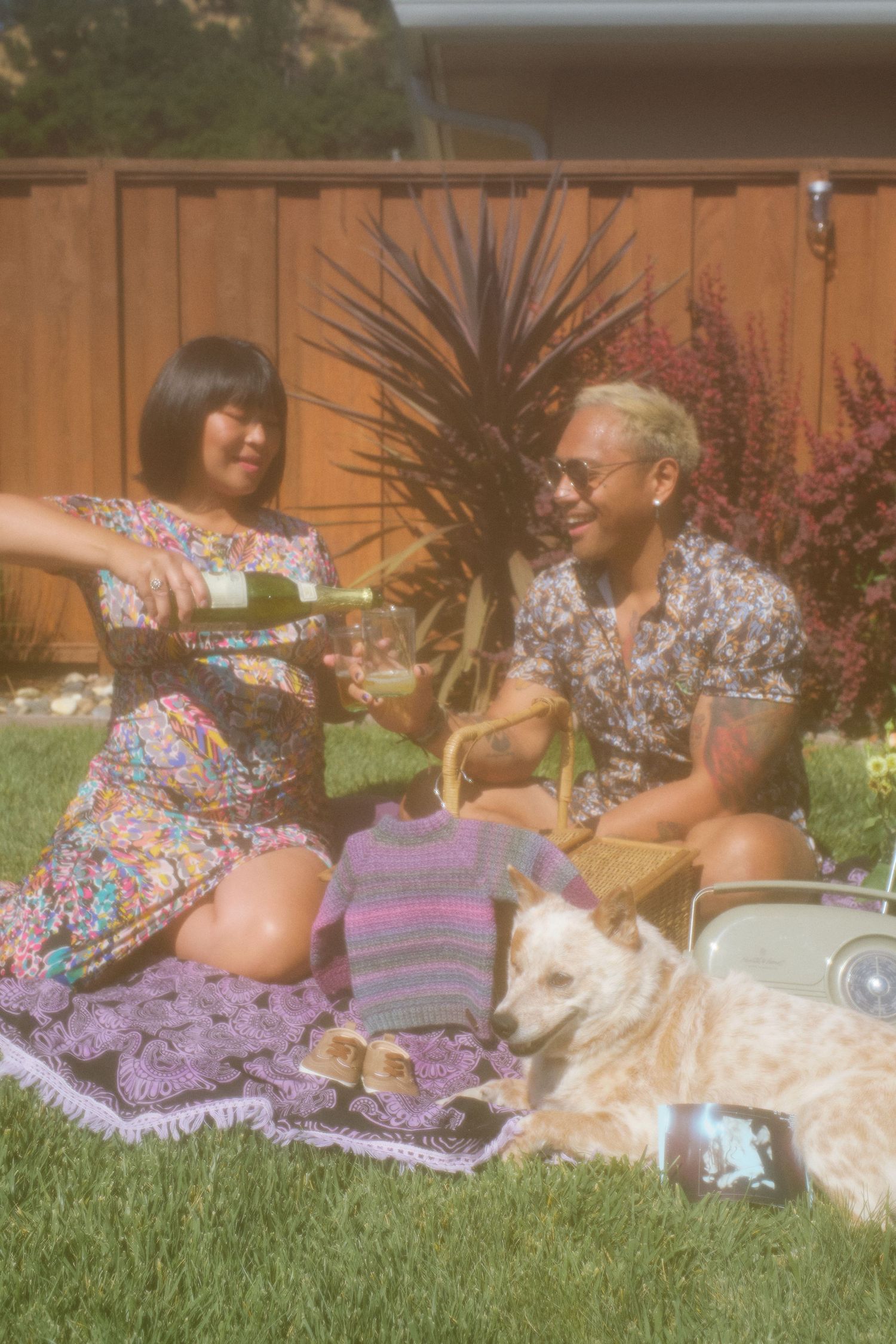 Maternity photography of a couple posing on picnic blanket in Martinez, CA.