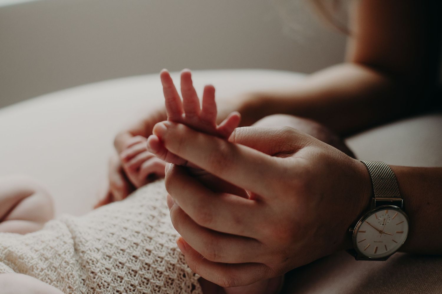 Close up of baby hand in moms hand