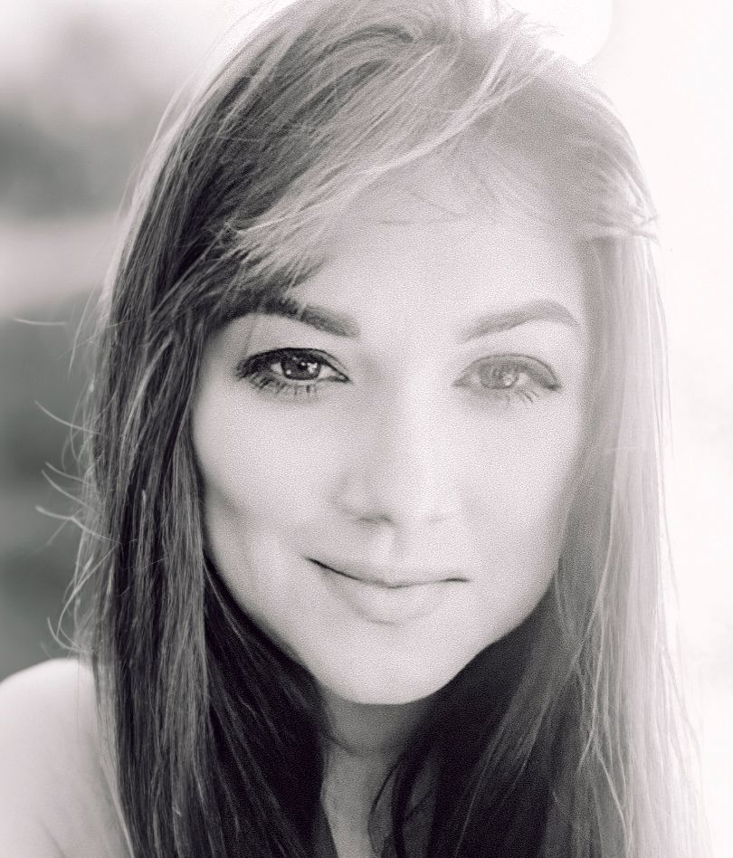 Portrait photography with soft lighting and gentle expression in black and white tones.