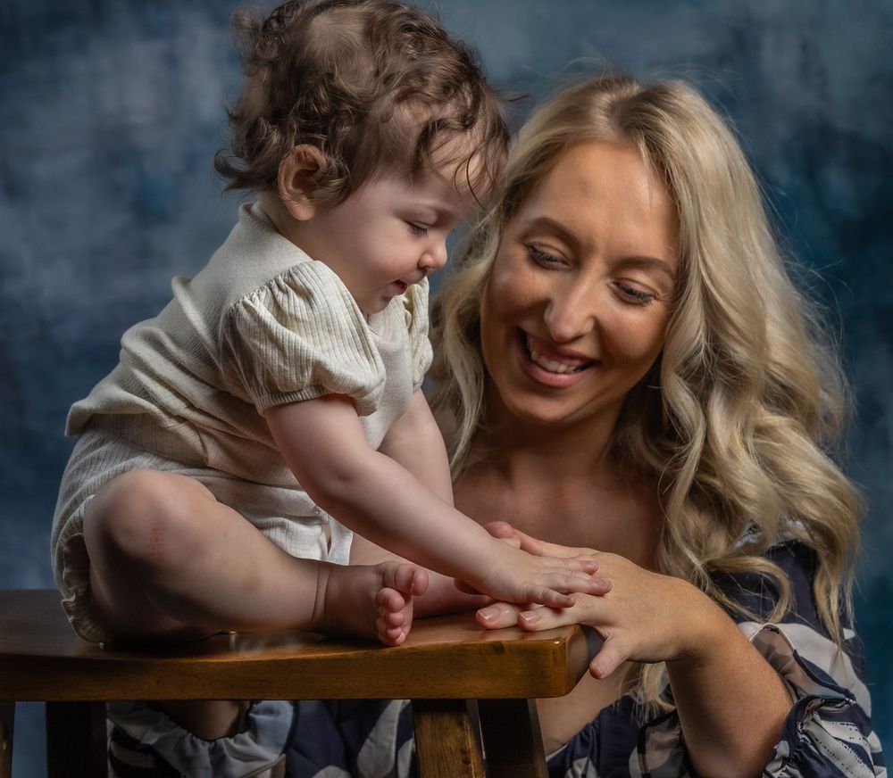 Candid studio portraits capturing natural laughter and connection between parent and child.