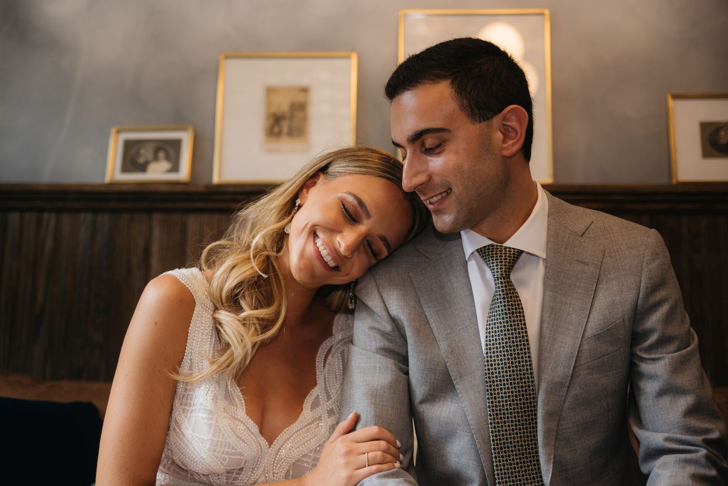 Intimate wedding portrait in warm lighting with natural expressions.