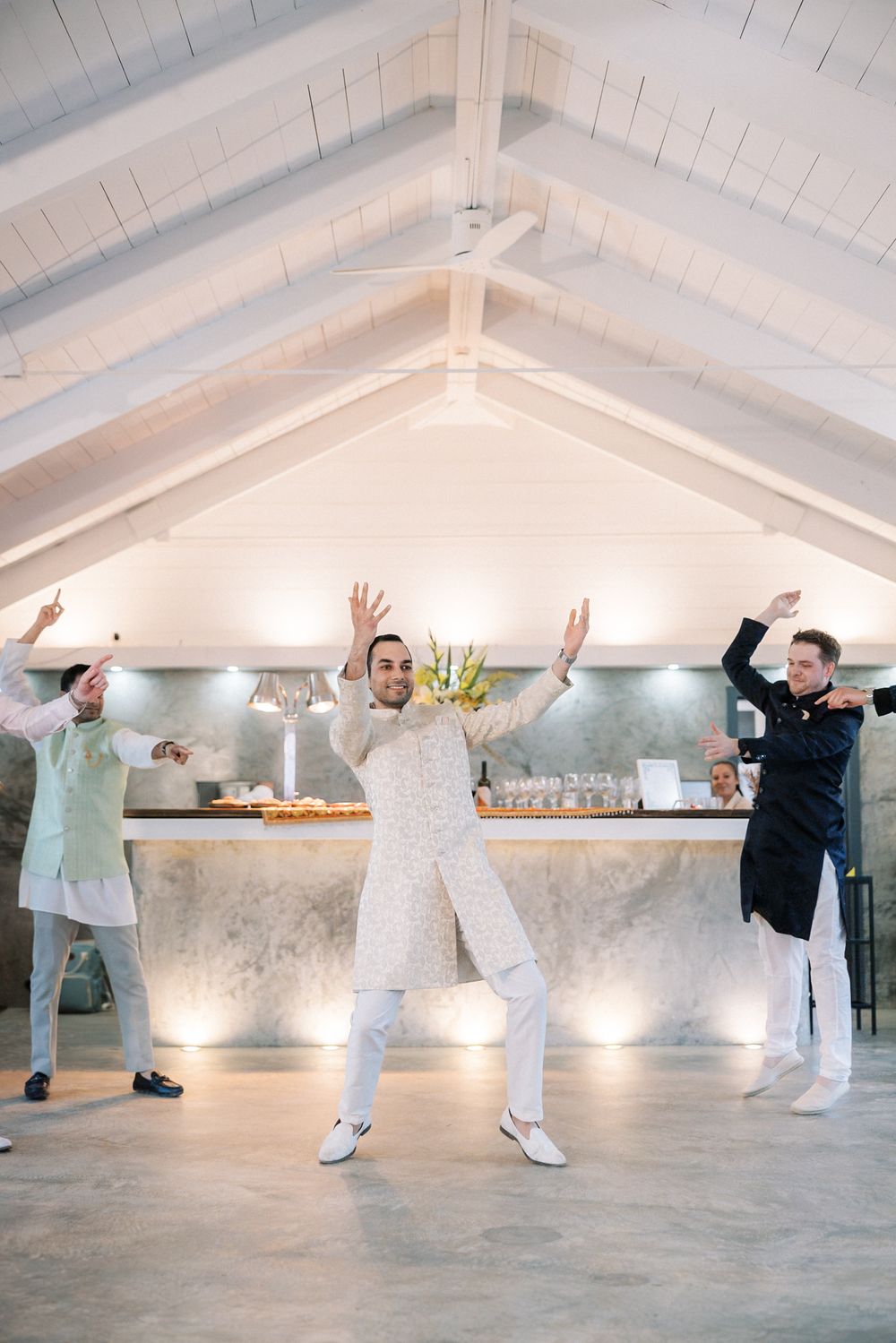 groom and groomsmen dancing together during the Sangeet celebration at Casa da Guia in Cascais, Portugal.