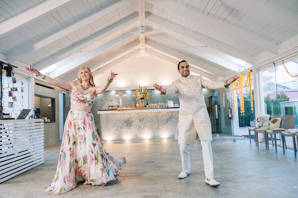 Bride and groom dancing together during their Sangeet celebration before their destination wedding in Portugal.