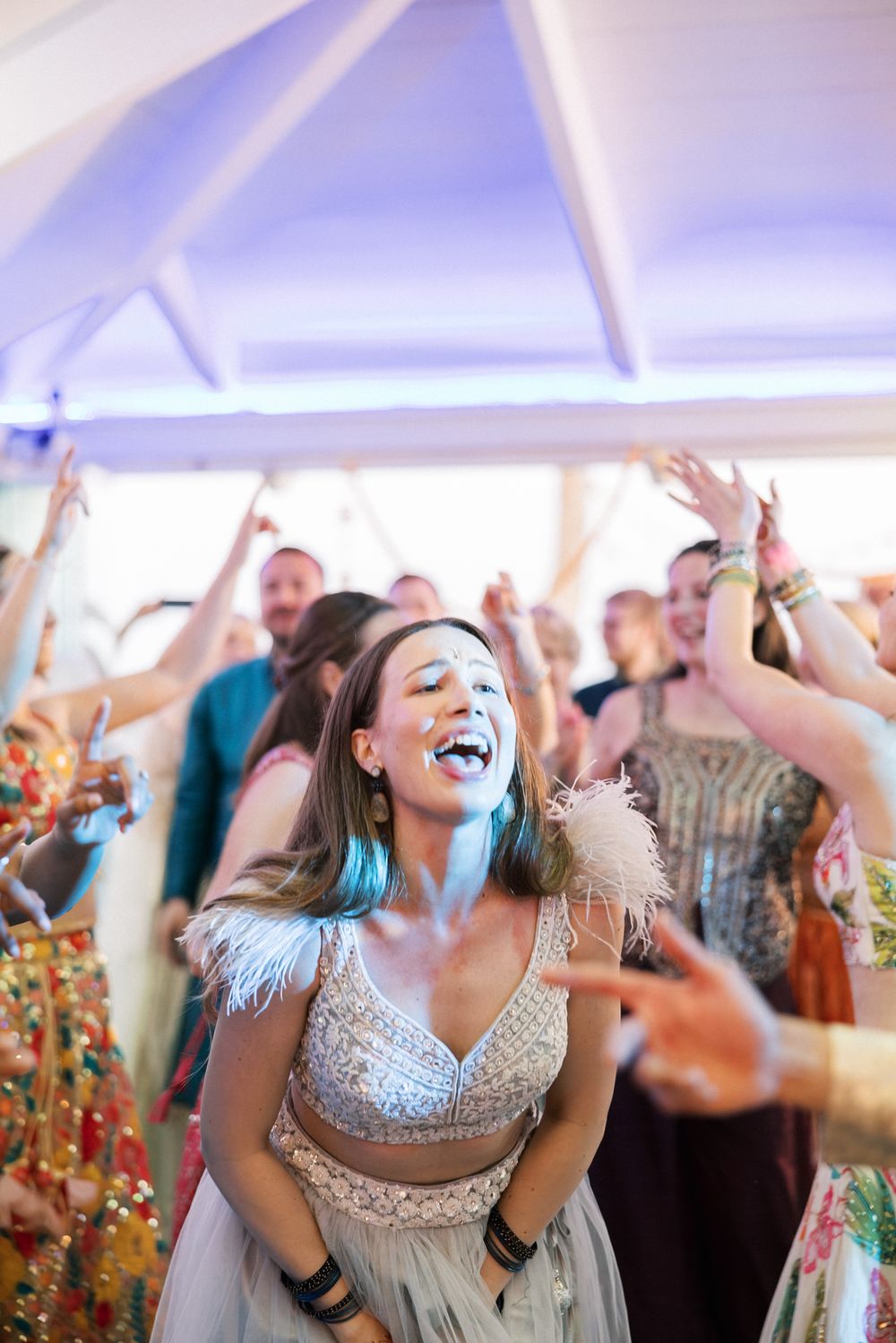 Family and friends celebrating on the dance floor during an Indian destination wedding in Portugal.