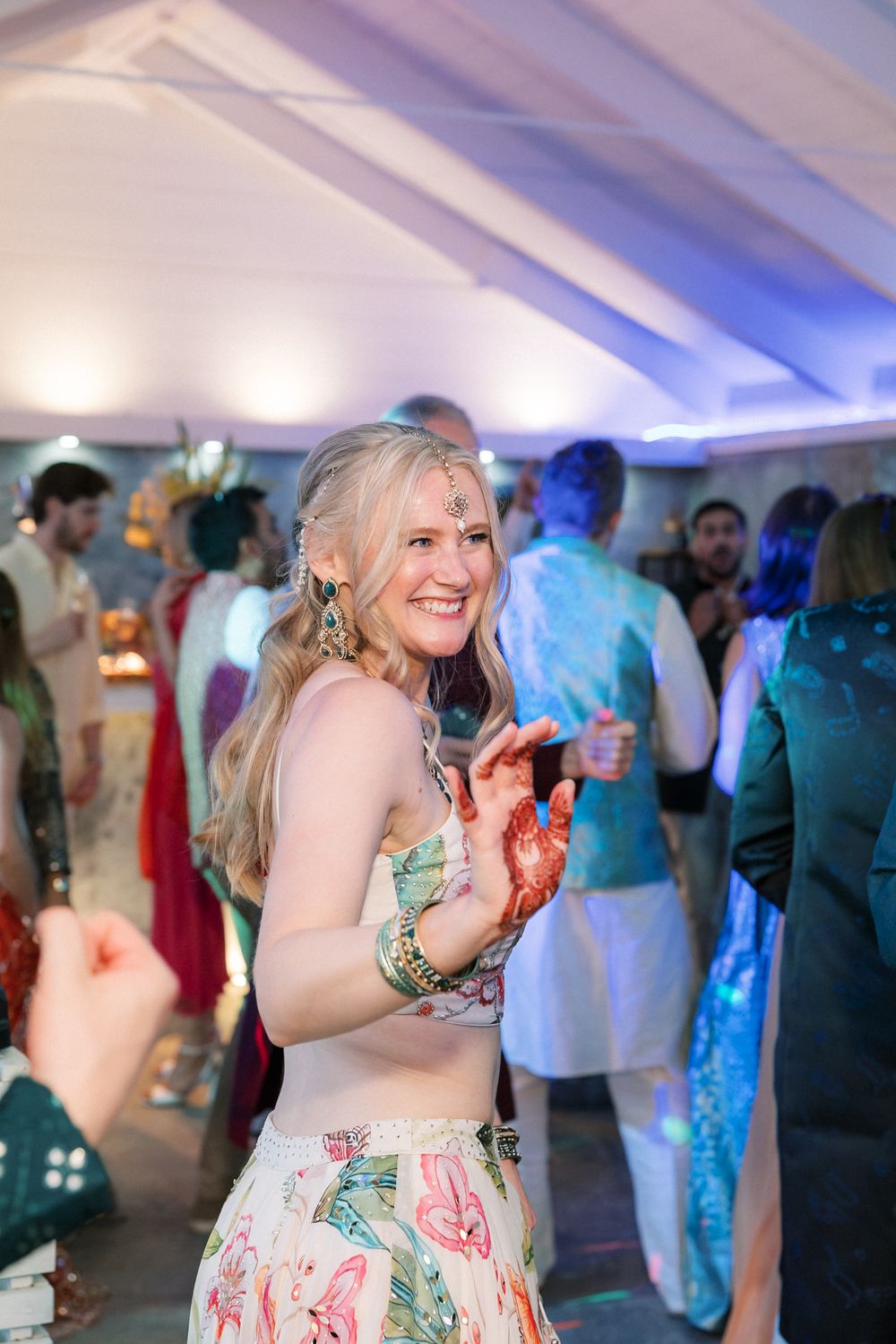 Bride dancing during the Sangeet celebration by the sea at Casa da Guia in Cascais, Portugal before her destination wedding.