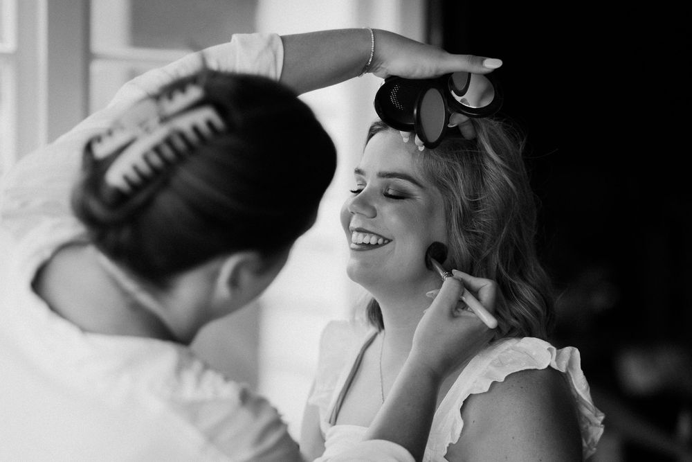 A black and white photo collage showing close-up profile shots of someone laughing and smiling.