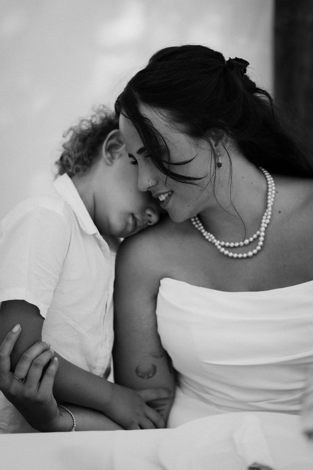 Black and white sequence of intimate mother and child moments showing tender bonding and affection.