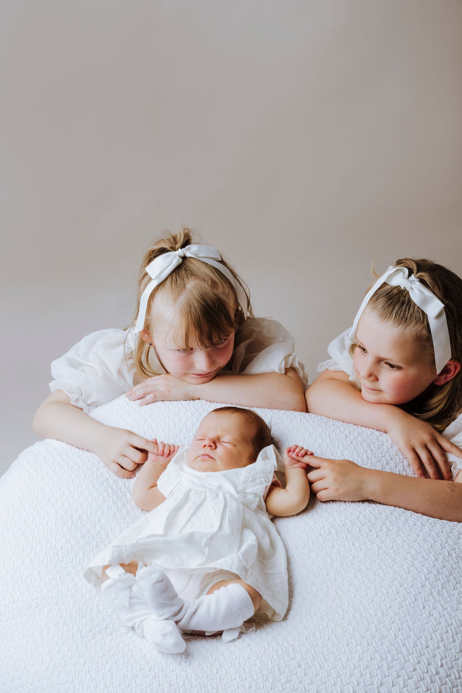 newborn and sisters