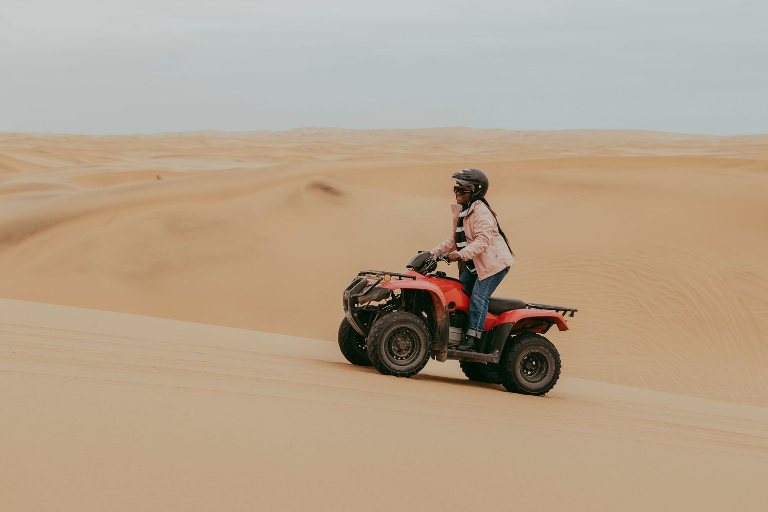 Visitor riding a quad bike through the Namib Desert dunes