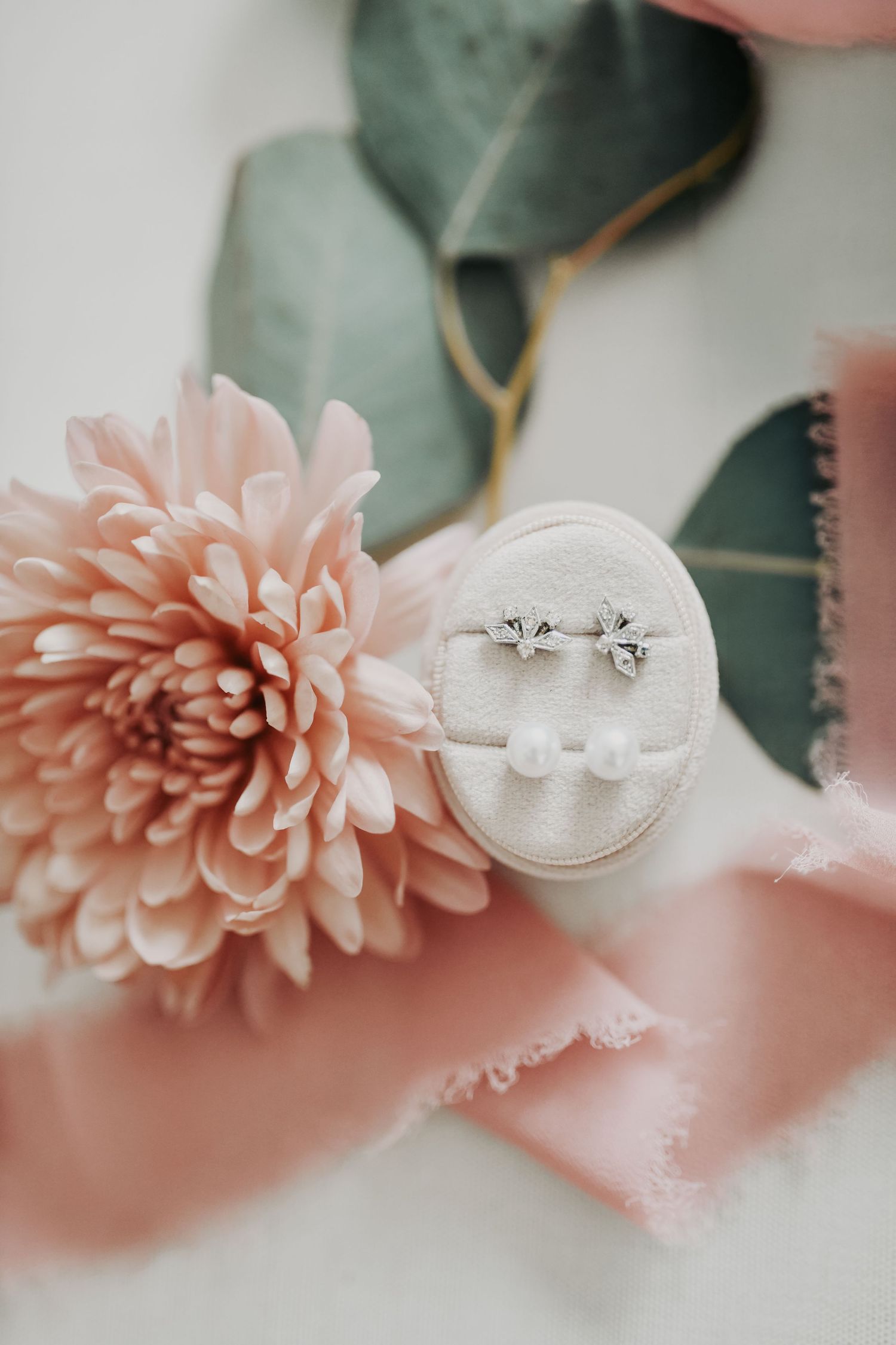 Bride's wedding vow book and jewelry arranged for a romantic wedding flat lay