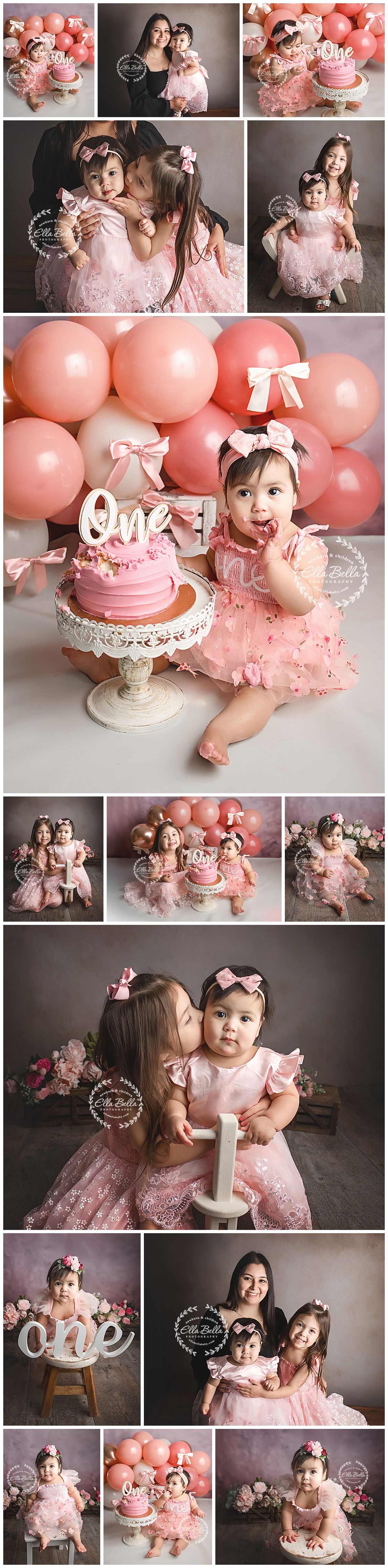 Baby girl in a pink tulle dress and bow headband enjoys her first birthday cake smash beside a pink and peach balloon garland.