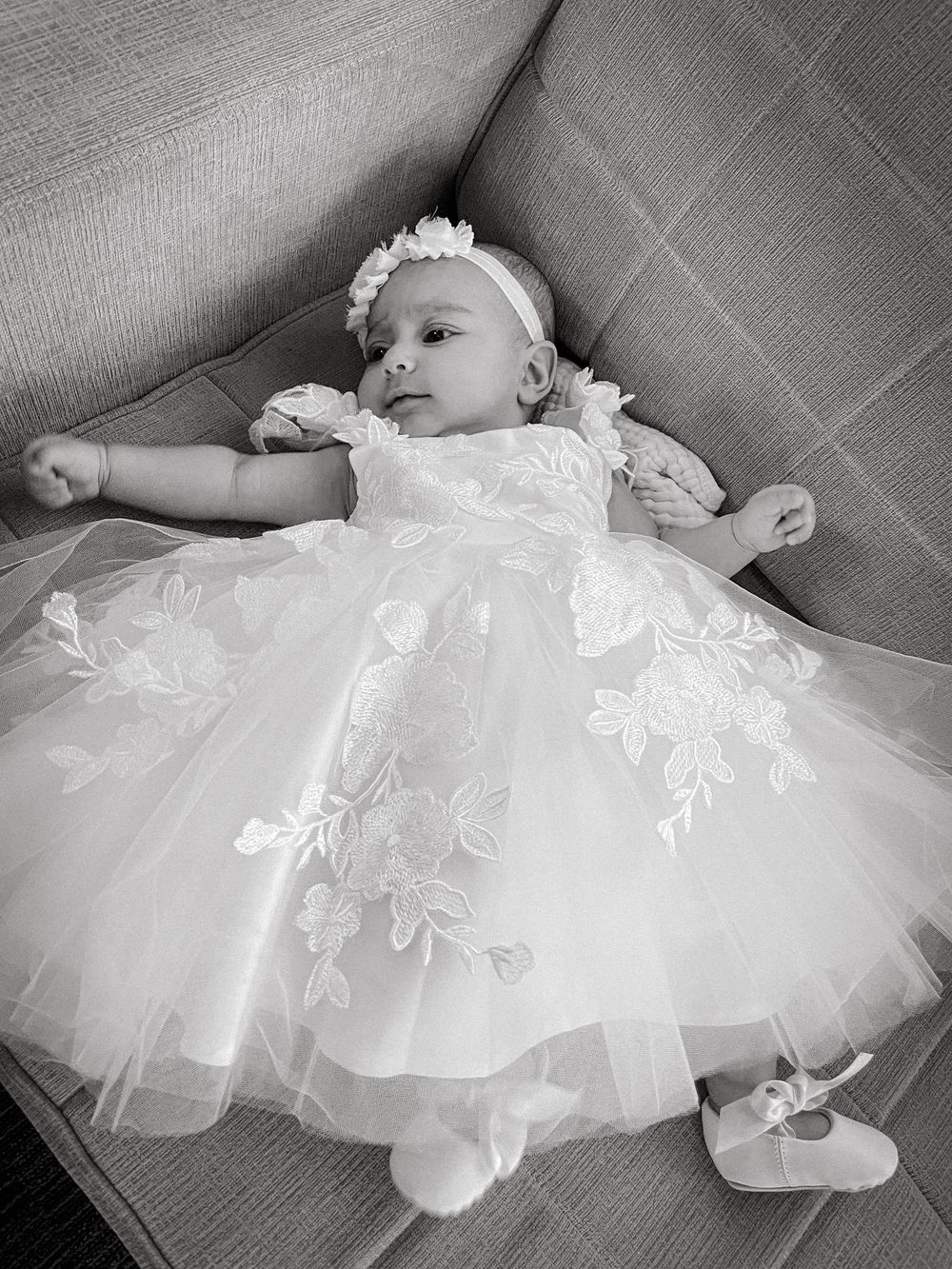 Black and white photo of a baby girl in a lace christening gown and headband, New Jersey baptism photos