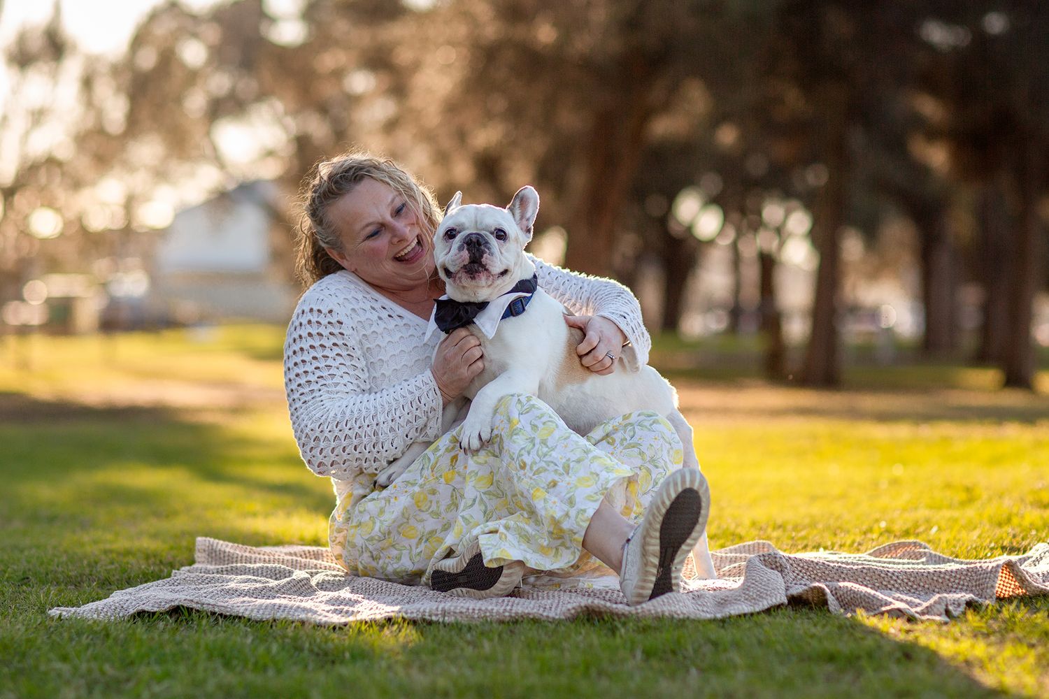 French Bulldog and owner sharing a cuddle during a pet photo session in Perth
