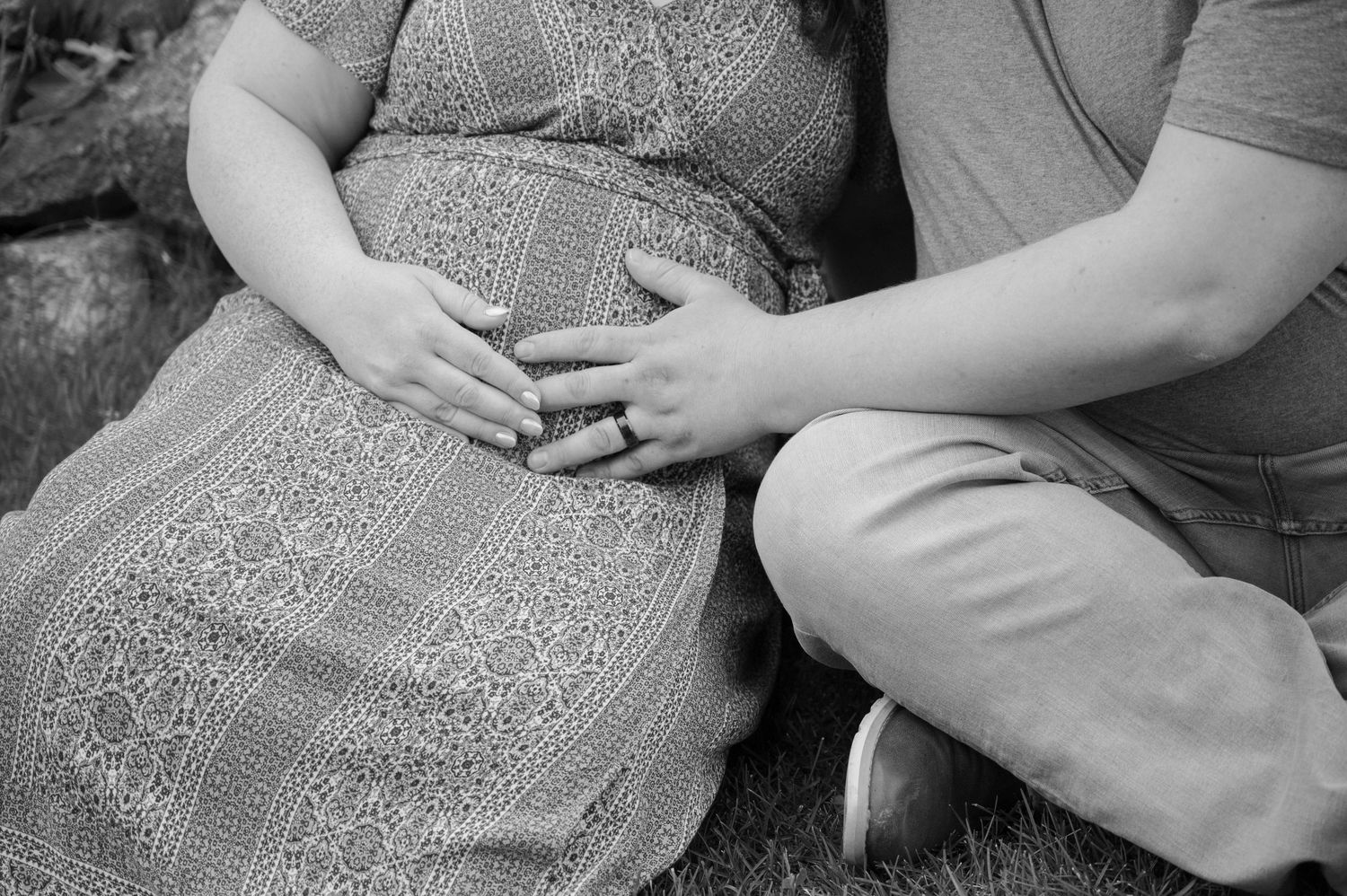 couple holding pregnant belly
