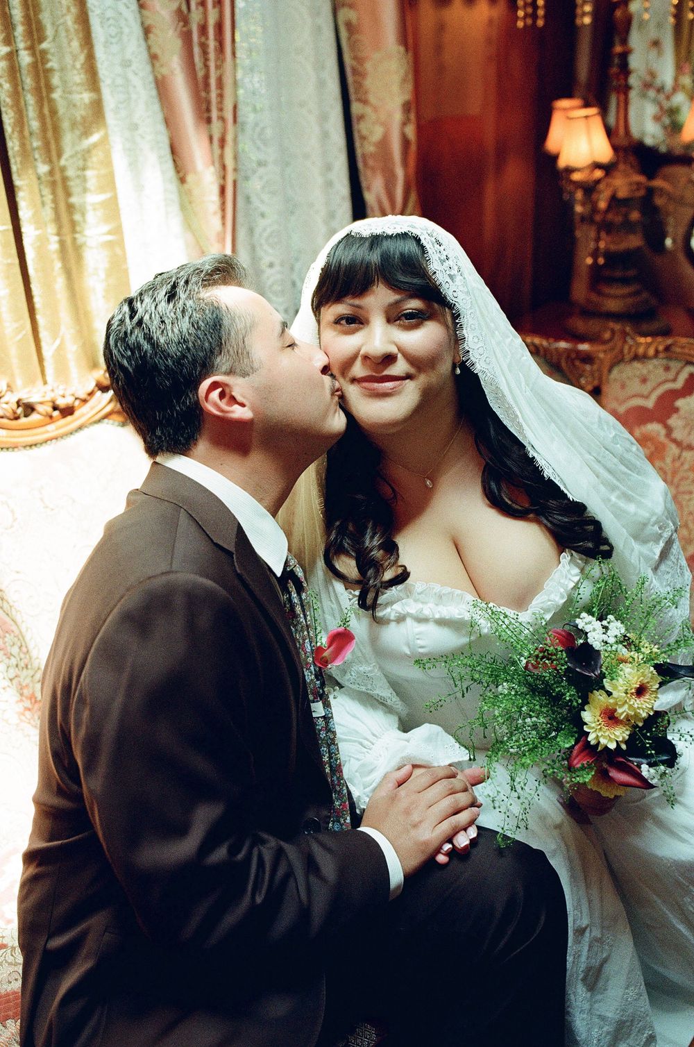 film wedding photography image of groom kissing bride on cheek