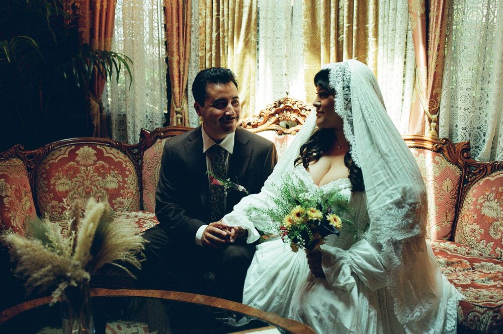 film wedding photography photo of bride and groom siting on vintage sofa in los angeles