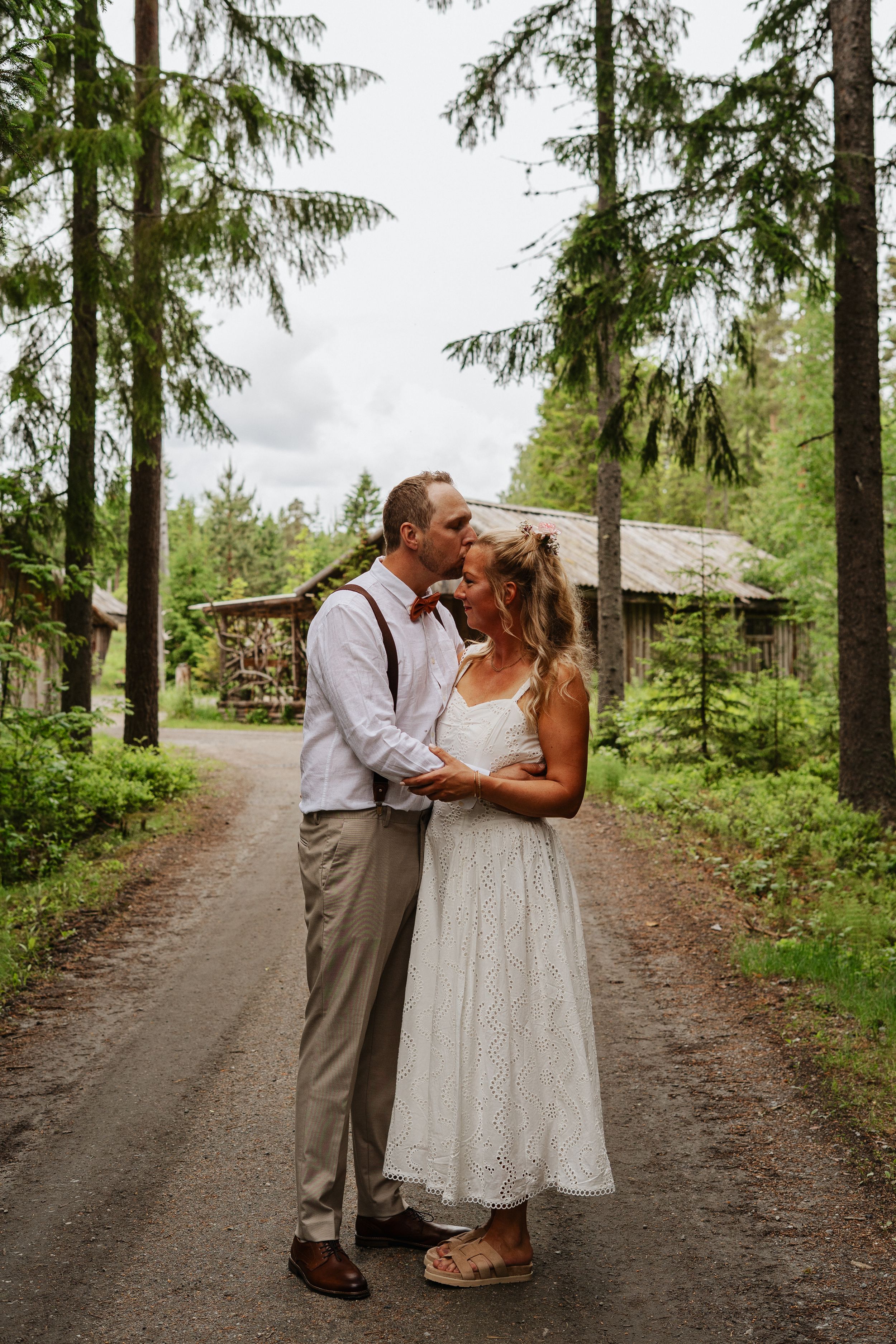 Brudpar håller om varandra under sin bröllopsfotografering i Ockelbo